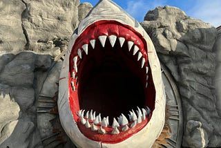 A fake mouth of a shark opens with sharp teeth.