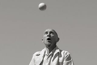 A man juggling multiple balls