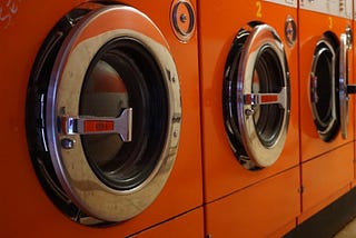 Three washing machines in a laundry