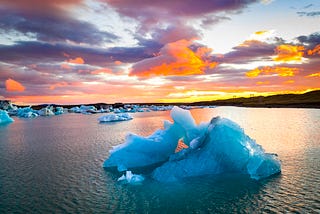 Ice melting on the sea at sunset