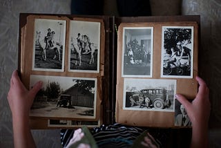 Photo of a person holding a book of black and white photographs