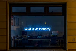 Neon Blue Sign that Reads What is Your Story