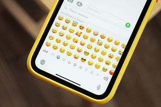 Photo of a phone displaying the emoji keyboard.