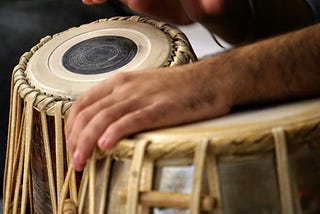 close up color photograph of person playing the djeme drums