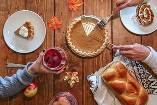 Pumpkin pie, homemade bread, and cranberries to celebrate Thanksgiving.