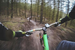 A cyclist riding through a winding forest trail, symbolizing the journey toward balance and finding an easier path in life.