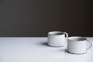 Photo of two ceramic mugs together on a table
