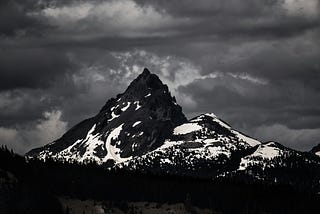 black and white picture of a huge mountain with snow fields