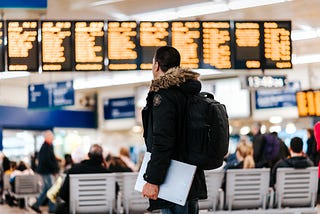 A person carrying laptop and preparing for departure at the airport.