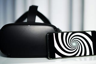 A V. R. headset with a phone displaying a hypnosis swirl