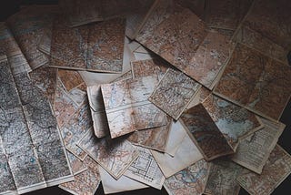 Several maps spread out on a surface