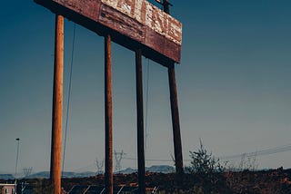 An old faded billboard that reads, “NOTHING”.