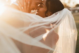 Couples romantically posing for a photo at their wedding