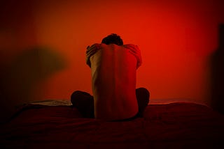 Man sitting on bed facing his fears