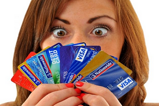 Woman looking at multiple credit cards
