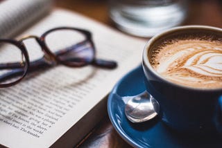 Coffee and poetry and a pair of glasses.