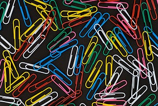 Colored paper clips spread out on a table
