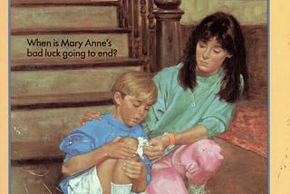 Mary Anne helps a young boy who has scraped his knee.