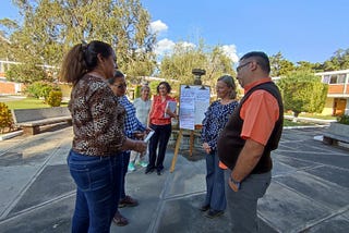 A group of people discussing a topic or an exercise during a training session outdoor in Guatemala City