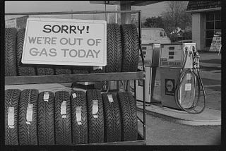 Out of gas sign on tire rack at gas station during Oil Embargo, January 29, 1974.