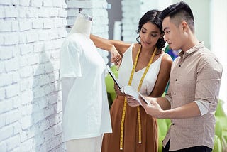 Two people checking the apparel’s proper sizing