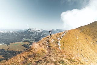 A man at the top of a mountain