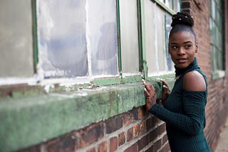 Lovely Black woman near an old building