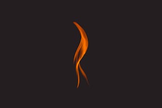 A single flame with a black background.