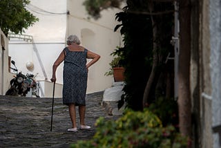 a lady walking with a cane