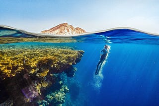 Lady diving in the ocean.