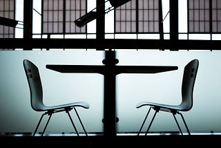 Two empty chairs facing each other.