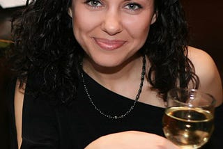 A photo of a beautiful Russian woman holding a glass of champagne