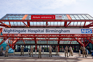 A team of veterans stands guard outside Nightingale Hospital in Birmingham. Photo credit: Jacob King/PA