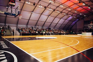 Basketball court with fans seated in the bleachers