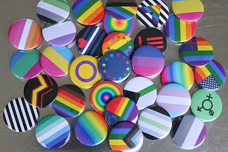 Pins of various colors and symbols depicting gender variety and identification