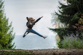 Woman Jumping Wearing Green Backpack. What happens when you do HIIT training for 3 months