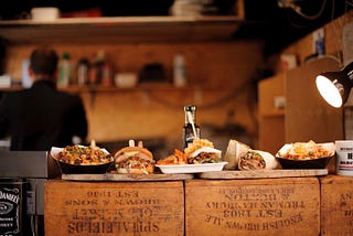 A burrito bar, with several dishes on plates sat out