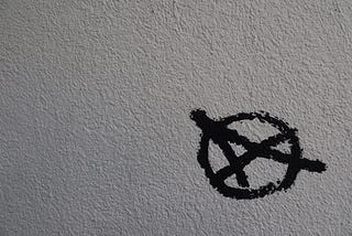 A capital letter A in a circle, painted onto a wall.