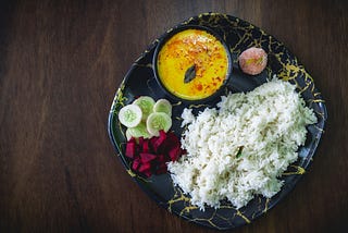 Kadhi chawal (Kadhi Rice) traditional north indian food, with some salad and sweet.