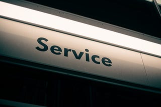 Street sign with the word “Service” lit up from above