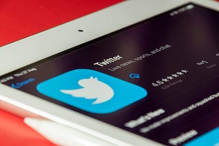 Decoding the Twitter Algorithm: 10 Secrets Revealed by Aakash Gupta. Twitter logo.