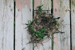 a nest sitting on a porch