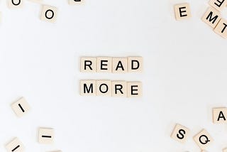 scrabble board with the text ‘read more’