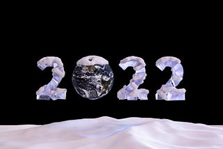 2022 written as big blocks of snow-covered ice with the zero represented by the Earth
