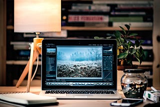 Open laptop on a desk with software loaded.