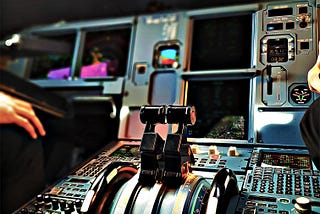 Flight deck of a passenger aircraft displaying complex set of controls.