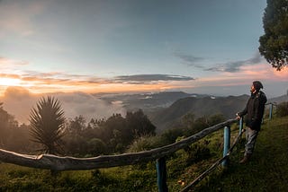 Someone surveys a beautiful landscape while he thinks