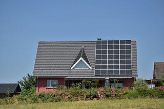 A home equipped with solar panels on its roof making home more energy efficient