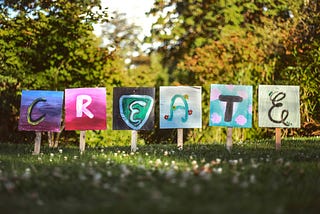 Signs spelling out the letters of the word ‘create’.