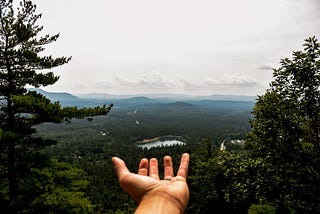 Hand reaching out toward the sky